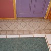 This ceramic tile rug right in front of the door is in lieu of ripping out all of the tile. Photo and tile repair by Kevin Stevens.
