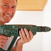 Photo of a man drilling with a power drill by nullplus/istockphoto.com.