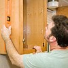 Photo of a carpenter installing kitchen cabinets by lisafx/istockphoto.com.