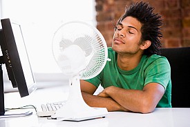 A man survives hot weather by cooling himself with a fan. (Photo: monkeybusinessimages/istockphoto.com)