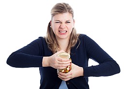 This lady is struggling to open a jar. Too bad she didn't read this article. (Photo: JanMika/istockphoto.com.)