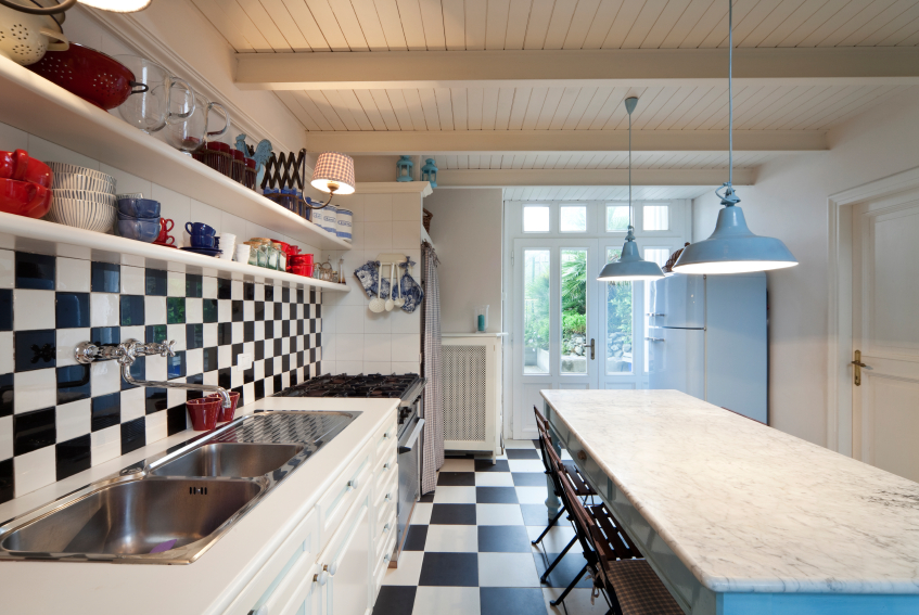 Photo of a black and white tiled kitchen in a luxury apartment by piovesempre/istockphoto.com.