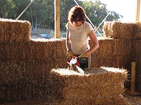 An electric chainsaw in action in the construction of a strawbale home. Photo: Brett and Sur Colstock/Flickr