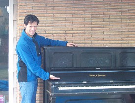 This is the author, with the piano that he is now storing on his back porch.