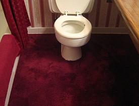 The carpeted bathroom and the dense floral wallpaper need to go. (Photo: rick/Flickr creative commons)