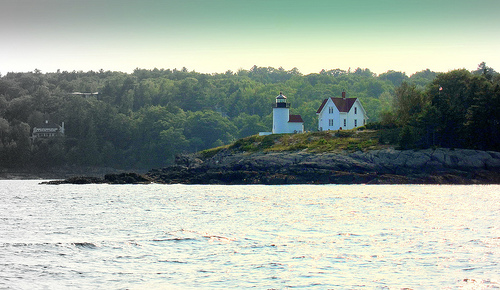 Photo of a house and lighthouse on Penobscot Bay by Librarygroover/Flickr.