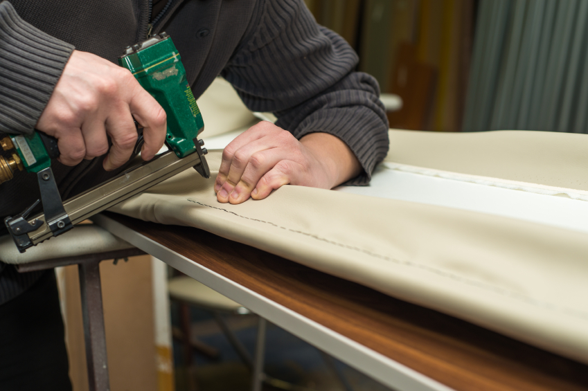 Photo of an upholsterer using an upholstery gun by AzmanL/istockphoto.com.