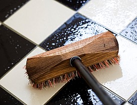 Photo of scrubbing a tile floor by eyewave/istockphoto.com.