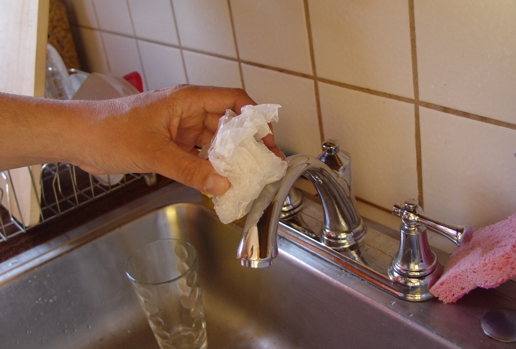 I'm cleaning the kitchen fixture with wax paper. -- Adam