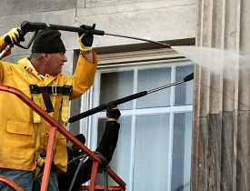 Hire a pro rather than power washing from a ladder.
