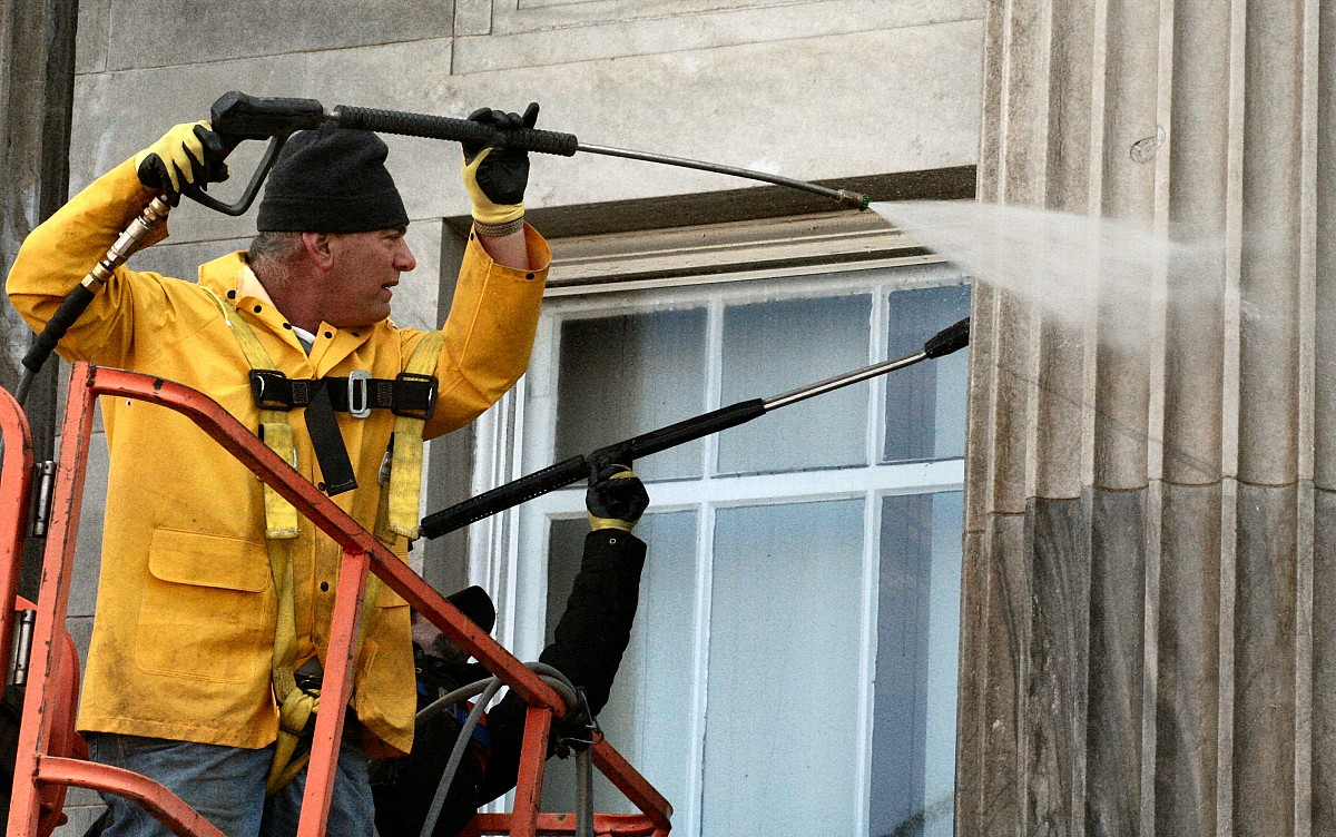 Hire a pro rather than power washing from a ladder.