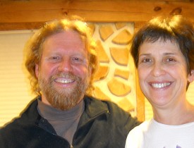 Todd Muller and Patty Smythe in front of a cordwood wall.  Photo: Cris Carl.