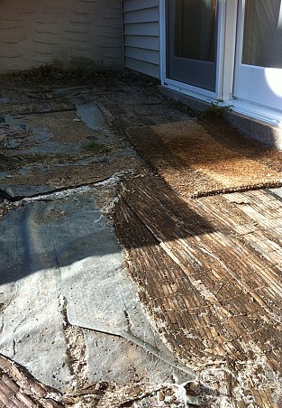 This is the patio now: bamboo mats are covering landscaping plastic and sand.