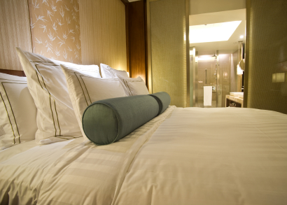 Photo of hotel bed by ymgerman/istockphoto.com.