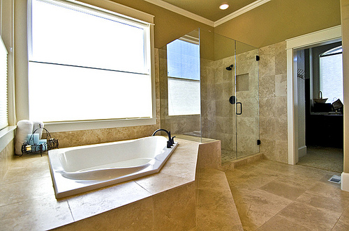 Travertine tile around tub and shower